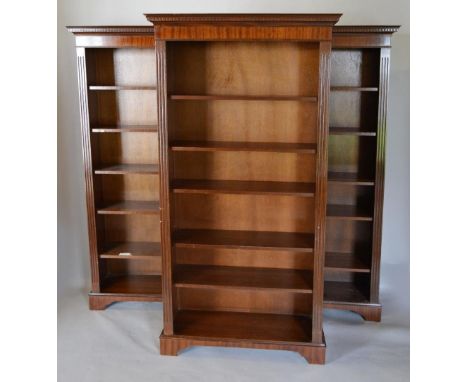 A Set of Three Reproduction Mahogany Bookcases, each with a moulded cornice above adjustable shelving flanked by reeded colum