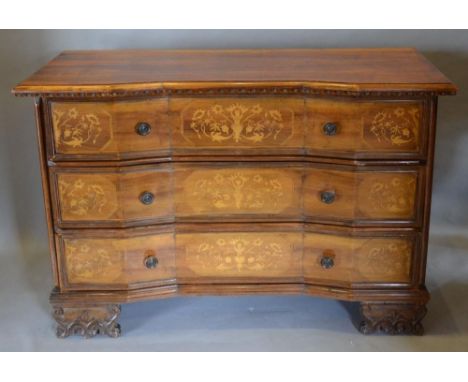 An Italian Walnut Marquetry Inlaid Inverted Commode with three drawers with circular brass handles raised upon carved, shaped