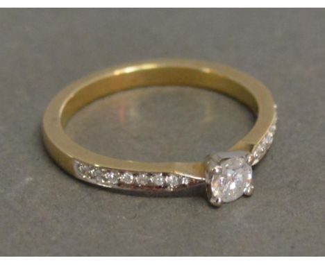 A 9ct. Yellow Gold Solitaire Ring with Diamond Shoulders, approximately 0.36 ct 