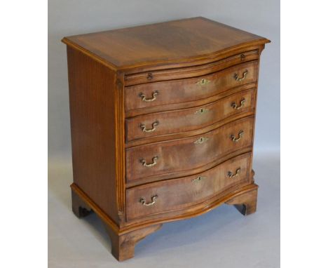 A Good Quality Reproduction Mahogany Serpentine Chest, the crossbanded moulded top above a brushing slide and four long drawe