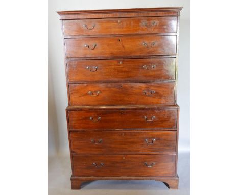 A George III Mahogany Chest on Chest, the moulded cornice above seven long drawers with brass swan neck handles, raised upon 
