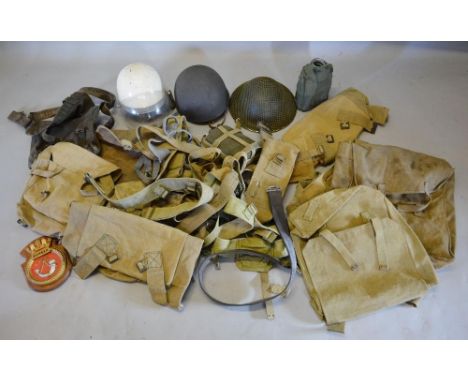 A Collection of Army Issue Accessories to include three helmets, a ship's badge, various water bottles and other items 