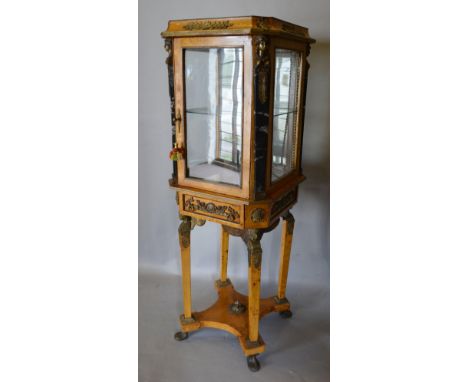 A French Gilt Metal Mounted and Marble Bijouterie, the top with a glazed door and four glazed panels enclosing a glass shelf 