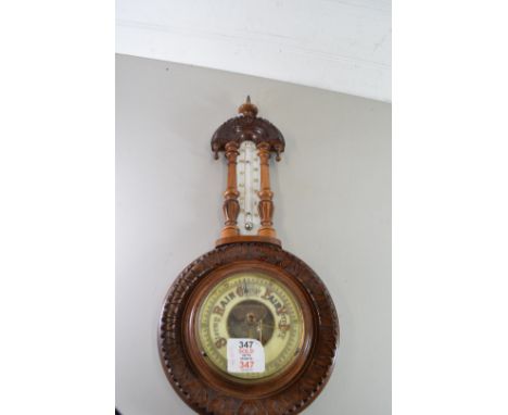LATE VICTORIAN ANEROID BAROMETER AND THERMOMETER COMBINATION SET IN A CARVED HARDWOOD FRAME