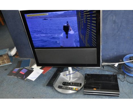 A BANG AND OLUFSEN BEOVION MX 31in TV ON MOTORISED STAND with a Beo4 remote, a Beocord V8000 VHS recorder, a Humax Freesat bo