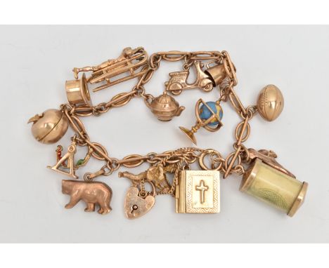 A CHARM BRACELET AND CHARMS, a yellow metal fancy link bracelet, fitted with a spring clasp, unmarked, fitted with a later ad