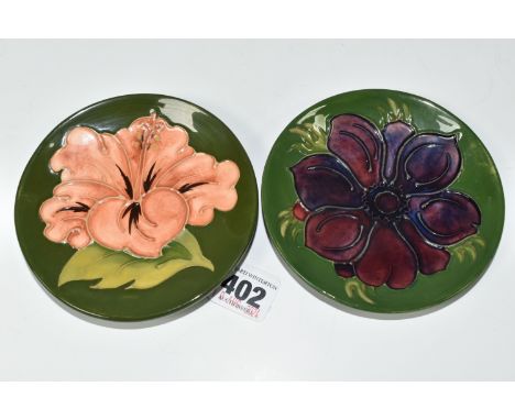 TWO MOORCROFT POTTERY TRINKET DISHES, tube lined in Coral Hibiscus and Anemone patterns, each on a green ground, diameters 11