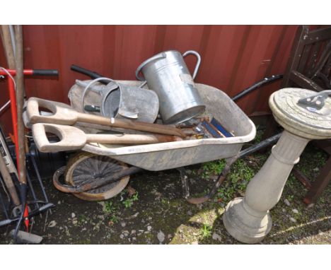 A BUILDERS WHEELBARROW AND GARDEN TOOLS including one modern and one vintage galvanised watering cans, forks, spades, a recor