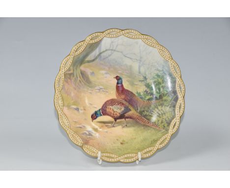 A MINTON CABINET PLATE PAINTED BY J E DEAN, with gilt gadrooned border surrounding a painting of two cock pheasants in a natu
