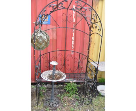 A MID 20th CENTURY WROUGHT IRON GARDEN BENCH WITH ARCHED ARBOUR width 124cm depth 62cm height 217cm alone with, a glass orb o