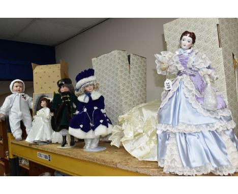 A GROUP OF PORCELAIN DOLLS, comprising of four Franklin Heirloom dolls with boxes, one dressed in a blue and lace ball gown, 