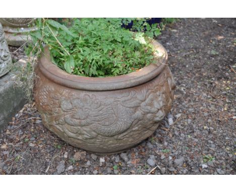 A LARGE ORIENTAL STYLE PLANTER with a terracotta coloured glazed finish and embossed detail to bowl rim diameter 46cm