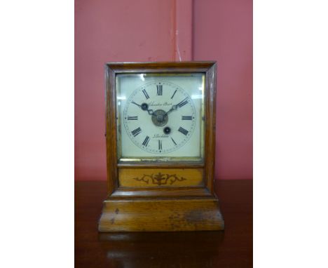 A 19th Century Irish inlaid oak mantel clock, the dial signed Schreiber Bros, Dublin