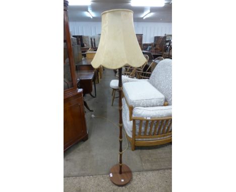 A teak standard lamp