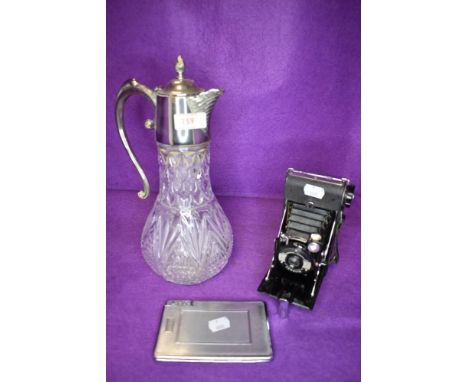 A Kershaw eight-20 Penguin camera, a decanter with silver plated handle and lid and a cigarette case with integrated lighter.