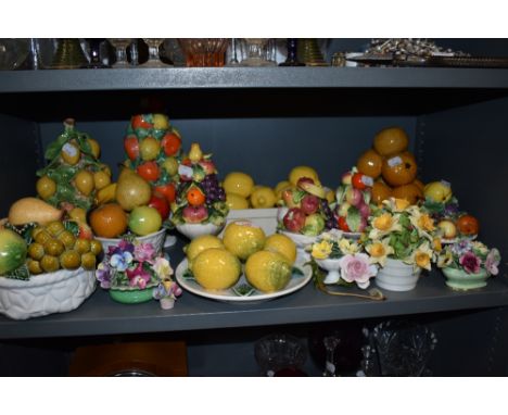 A selection of ceramic model fruit baskets and similar floral examples mostly from Portugal or Cappodimonte