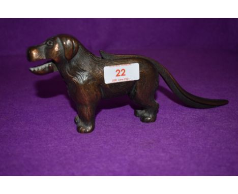 A vintage nutcracker in the form of a dog stamped made in England with reg mark