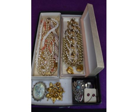 A tray of vintage costume jewellery including Trifari necklace and bracelet, enamelled jewellery including locket pendant by 