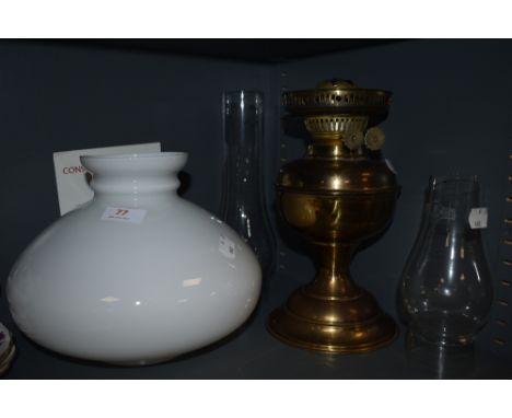 A brass bodies oil lamp with milk glass shade
shade, chimneys and oil lamp in good condition