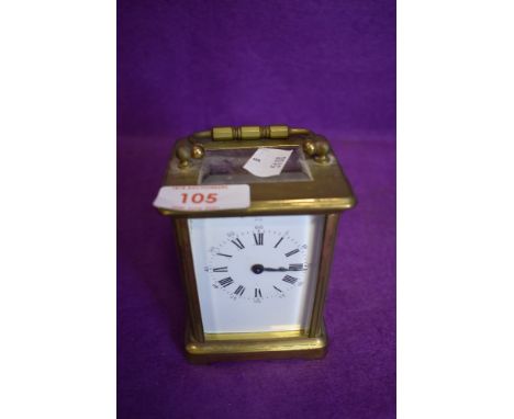 A brass cased French carriage clock having visible escape gallery and enamel face dials