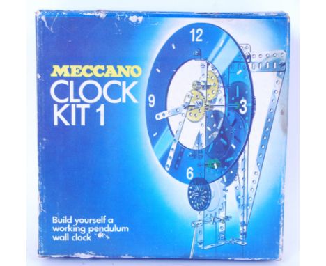 An original Meccano Kit 1 clock. Appears complete with parts to make the clock as well as drawings &amp; instructions to make