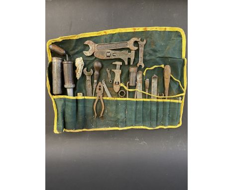 A tool roll with full contents including greasers, Dunlop tyre levers and several B.S.A. named spanners. 