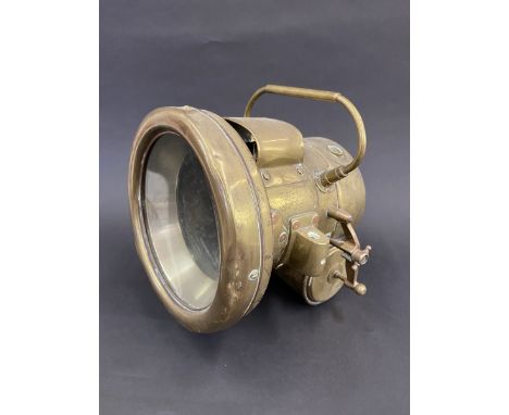 A large brass self generating lamp. 