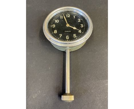 A Jaeger Swiss eight day car clock with long winding stem below. 