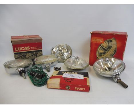 A collection of mostly Lucas new old stock including a revesing light with switch and bracket, a boxed Long Range Driving Lam