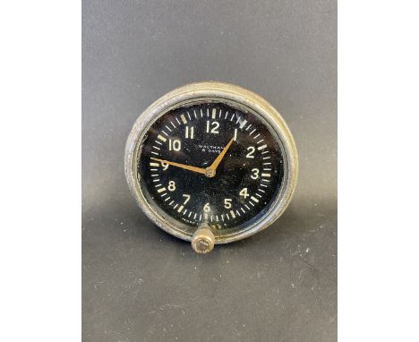 A Waltham eight day car clock with bottom wind.