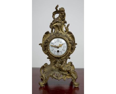 MANTLE CLOCK, 19th century French Rococo, enameled face with scrolling putti adorned bronze case, 30cm H. 