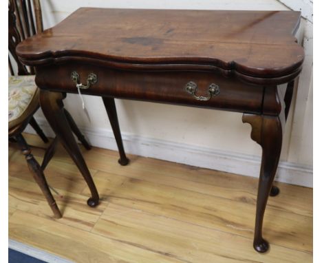 A George I red walnut serpentine top card table, with dished corners, frieze drawer and slender cabriole legs, width 82cmCOND