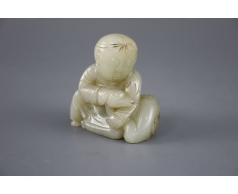 A Chinese pale celadon jade group of a seated boy and a duck, the stone with some occasional russet veining, Collection label