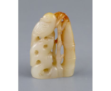 A Chinese pale celadon and russet jade carving of a bird on rockwork next to bamboo, 5.3cm