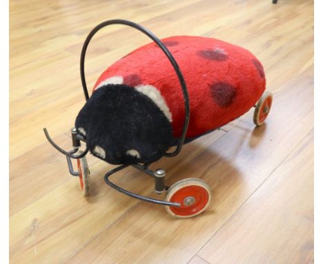 A vintage Steiff child's ride-on mohair ladybird, approx. length 54cm