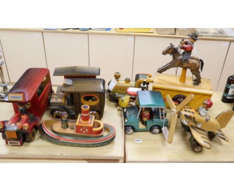 A collection of hand-crafted painted wooden toys, 1980's, comprising an automaton model of a cowboy riding a horse, a vintage