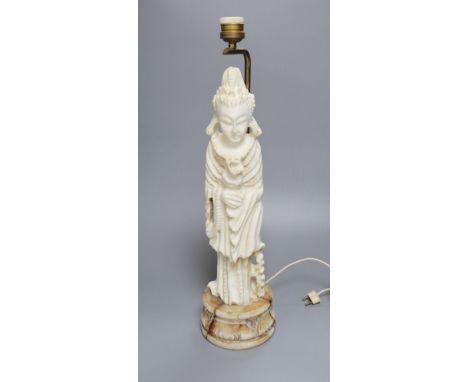 An alabaster carved figural lamp in the shape of Guanyin, overall height 54cm