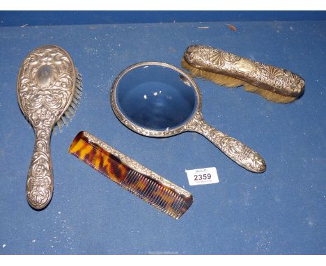 A three piece Silver Dressing table set hand mirror, comb and hairbrush, Birmingham 1965 by B&Co. and a Silver backed clothes