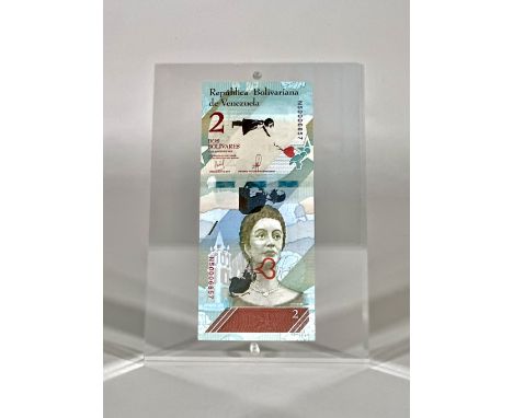 Banknote - Two venezuelans bolivares with "Ballon girl", entrance ticket to Dismaland Parkin 2015.