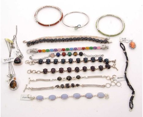 A mixed lot of silver and gemset jewellery: to include a multi gemset bracelet with drgaon head clasp, a faceted oval ruby br