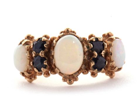 An opal and sapphire ring, the three slightly graudated oval opals, interspaced with two round sapphires to each side, all cl