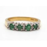 An 18ct emerald and diamond ring, set with four round emeralds interspaced with small round