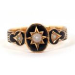 A 19th century mourning ring, the central oval panel with a gypsy set pearl surrounded by black