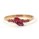 A 9ct ruby ring, set with two overlapping marquise shaped rubies with small round rubies to either