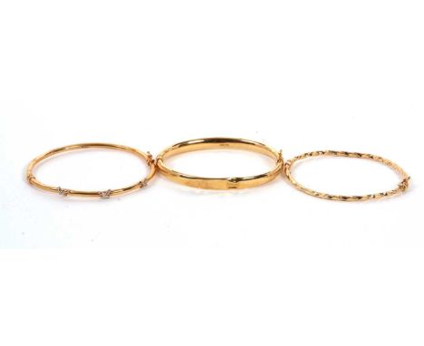Two 9ct bangles and another: to include a 9ct hinged bangle stamped 375 with Sheffield assay mark, 6.9g; a 9ct hinged bangle 