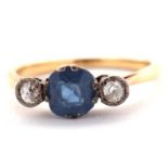 A sapphire and diamond ring, the central pale blue sapphire set to either side with an illusion