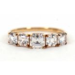 A 9ct white zircon ring, the five graduated square step cut white zircons, all claw mounted to a