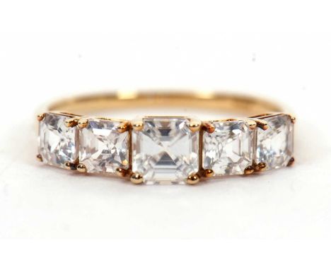A 9ct white zircon ring, the five graduated square step cut white zircons, all claw mounted to a plain band hallmarked Birmin