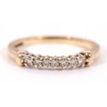 A 14ct diamond ring, set with small round diamonds with plain band indistinctly stamped 585, size L,