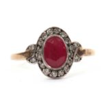 A 15ct ruby and diamond ring, the oval mixed cut ruby, collet mounted and surrounded by small